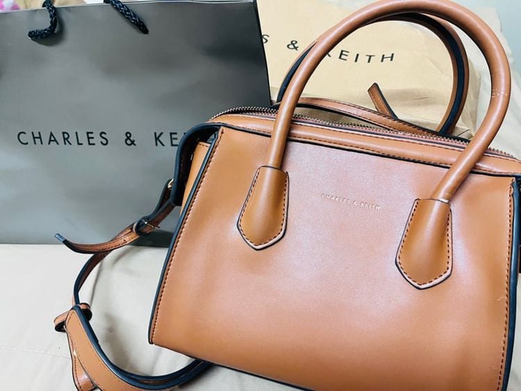CHARLES and KEITH ส่งต่อ กระเป๋าสะพายทรงหมอนสีน้ำตาล Bags. Brown mid sized top handle bag featuring zipper closure