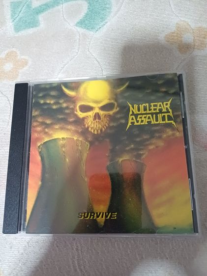 ภาษาอังกฤษ ซีดี CD เพลงแนว Thrash Metal วง Nuclear Assault อัลบั้ม Survive ปี 1988 แผ่น U.K. ส่งฟรีครับ