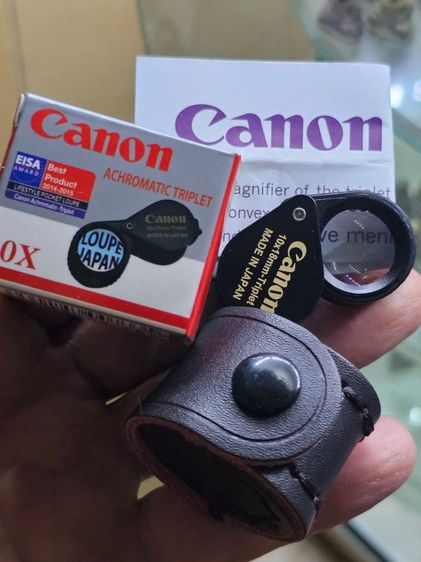 เลนส์มาตรฐาน Canon Triplet 10x18mm สีดำหุ้มยางเลนส์แก้ว 3ชั้นแบบ อะโครเมติก เคลือบมัลตโค๊ตสีฟ้าตัดแสงสะท้อน ตัวจับหุ้มยางกันลื่น พร้อมซองหนัง แถมฟรีผ้าเช็ดเลนส์ ของใหม่ นำเข้าจากญี่ปุ่น